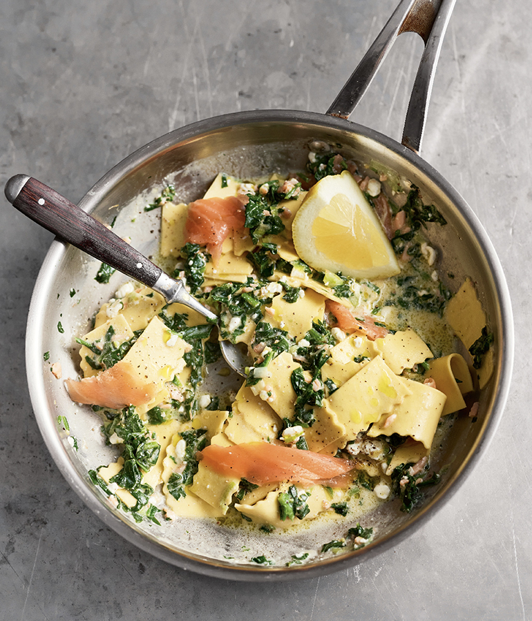 salmon, pasta, lemon and spoon in pan