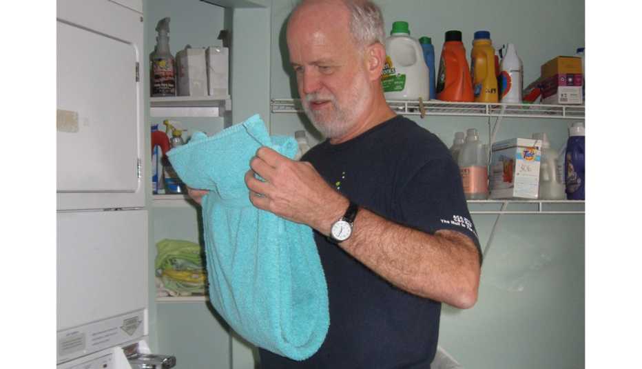 Man Does Laundry In The Shared Laundry Room, Co-Housing, Livable Communities