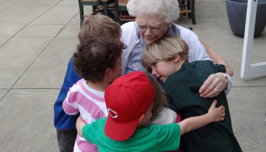 Maple Knoll Village, Children Hugging Grandfriend, Elderly Woman, Livable Communities, Build Bonds Across Generations