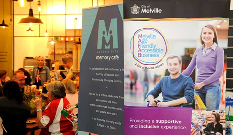 A poster for Melville Age Friendly Accessible Business showing a young man in a wheelchair and a young woman helper