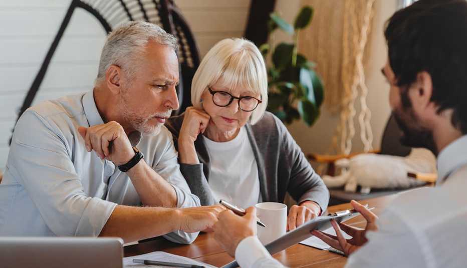 Financial advisor explaining paperwork to a man and woman