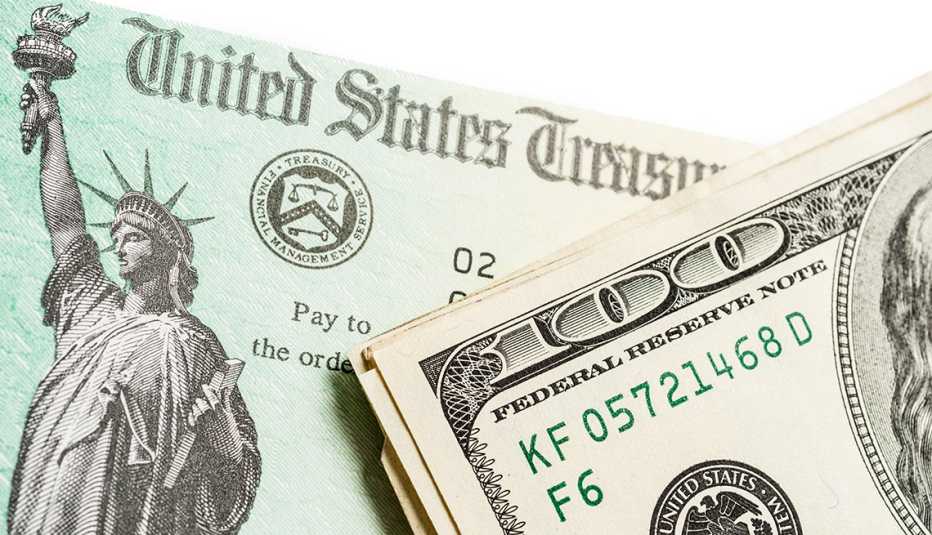 A treasury check with money next to it