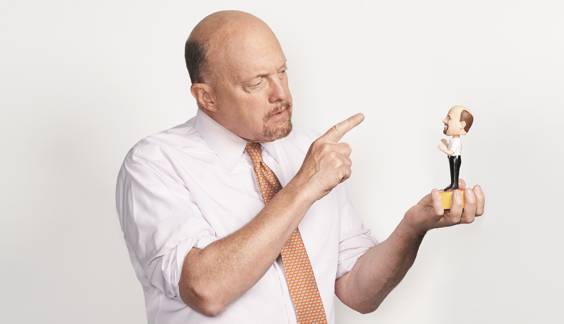 jim cramer pointing at a bobble head of himself