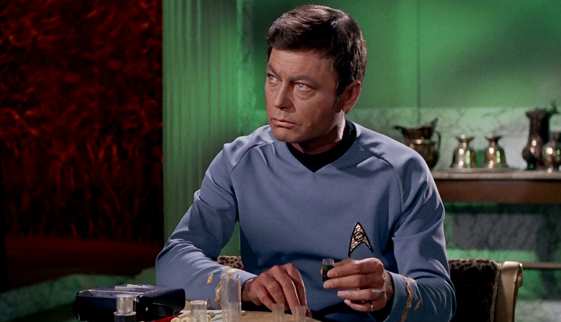 deforest kelley in his dr. bones mccoy costume on the set of star trek