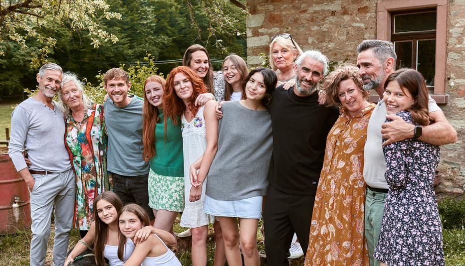 extended, multi-generational family posing for a photo outside
