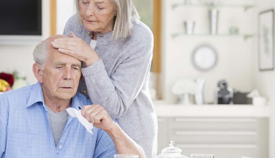 Older woman caring for sick older man