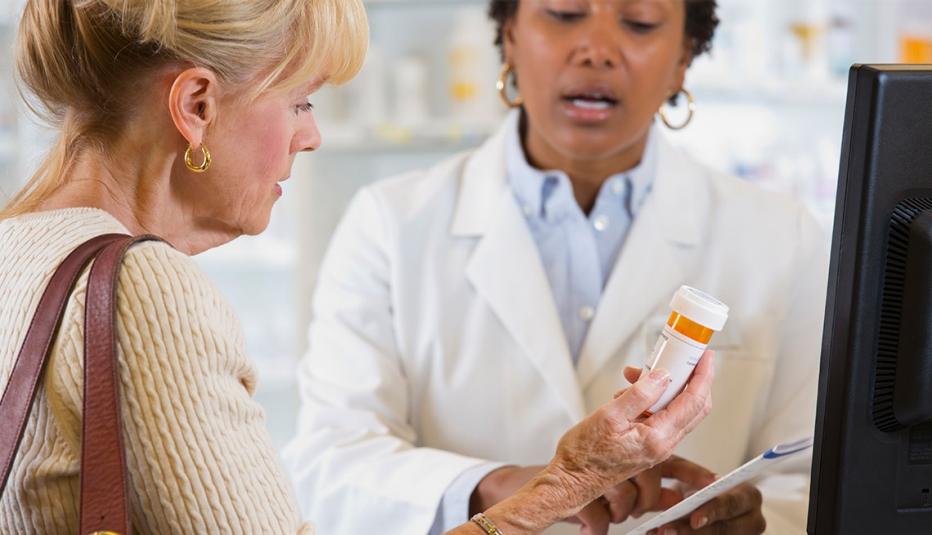 Older customer talking to pharmacist 
