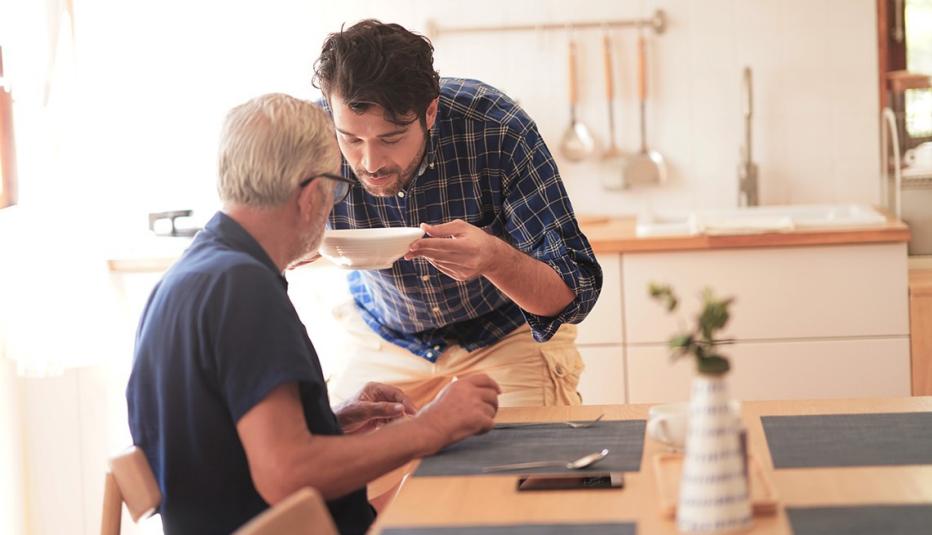 Son caring for older father at home
