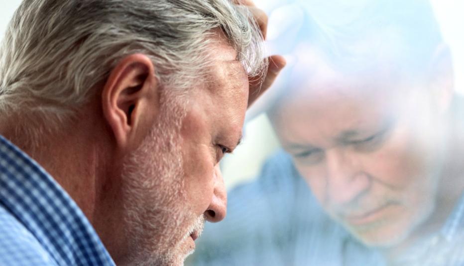 Concerned Senior Man at Window