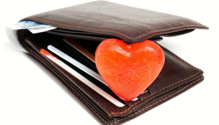 A wallet opened up with a heart shape inside