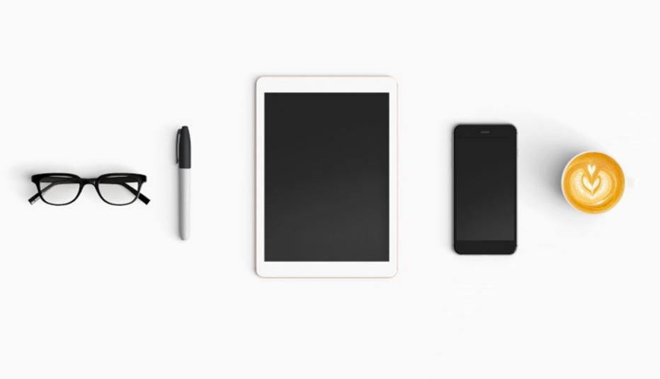 Tools for online banking: glasses, pen, tablet, phone, coffee