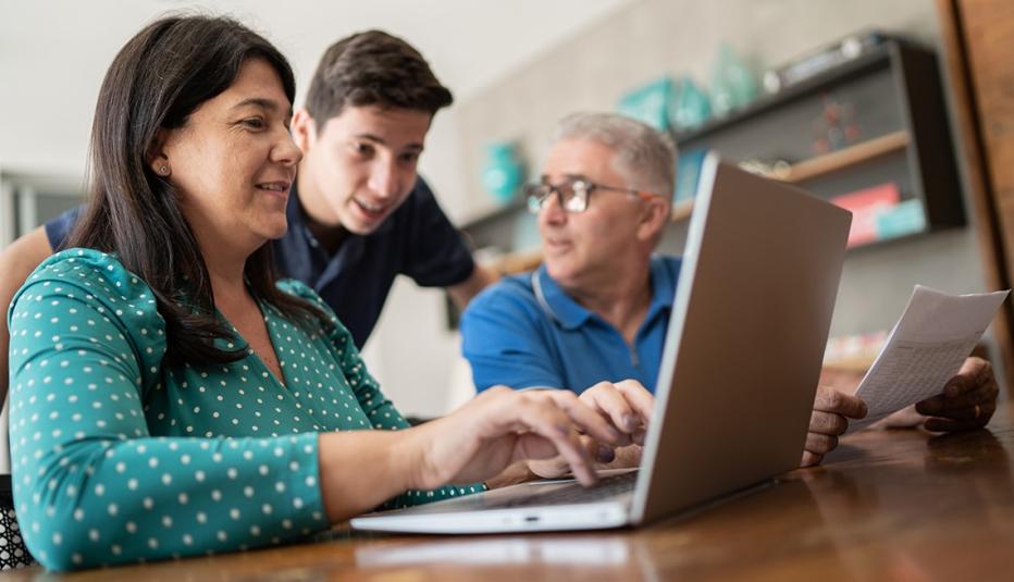 Parents doing home finances and talking to teenager son