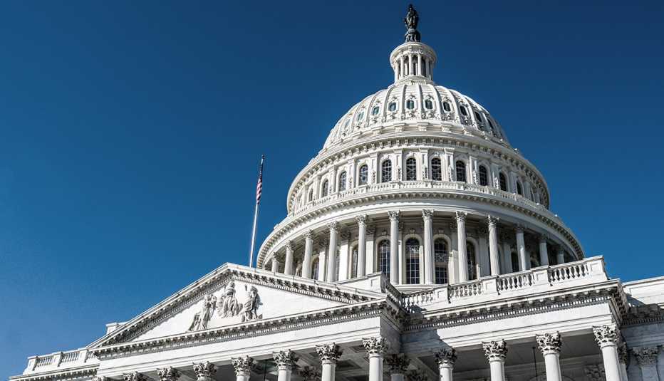 The dome of the United State Capitol against a deep blue sky in Washington, DC