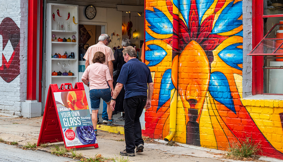 people walking into a glass blowing studio in the river arts district asheville north carolina