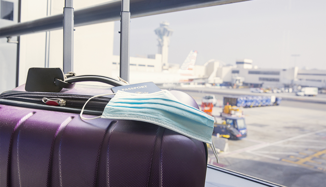 Passport, surgical mask on a suitcase