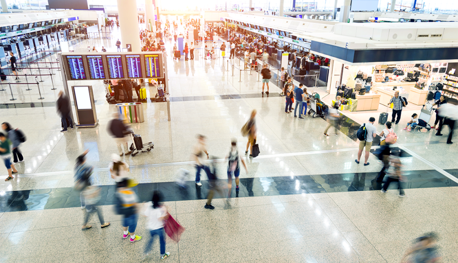 people walking through a busy airport