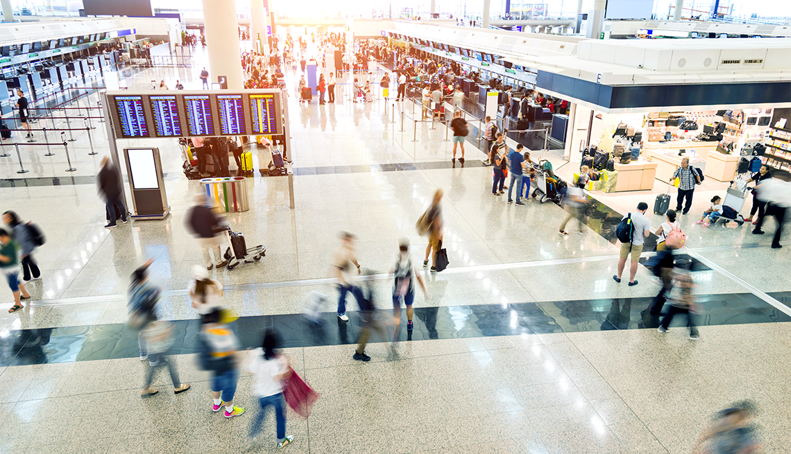 people walking through a busy airport