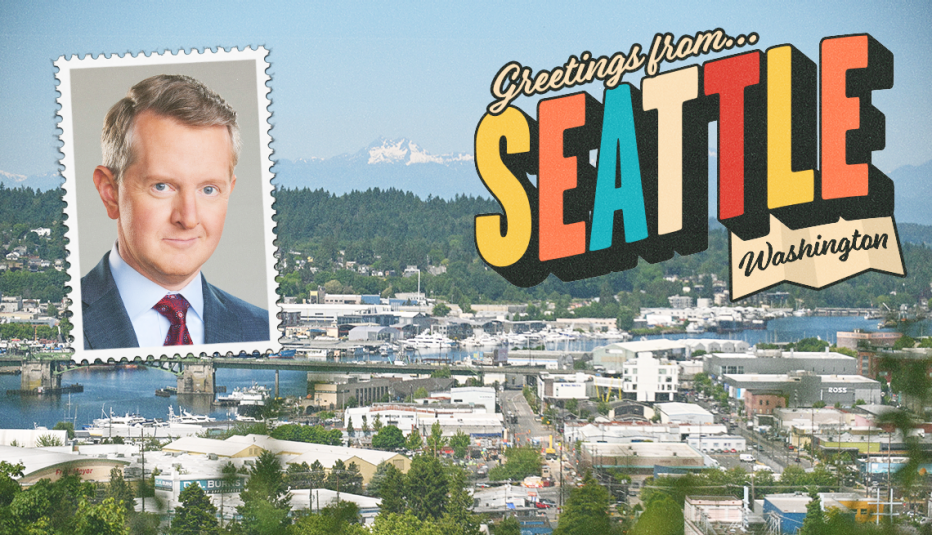 water, boats and buildings as background; photo of ken jennings in upper left corner; the words greetings from seattle, washington in upper right corner