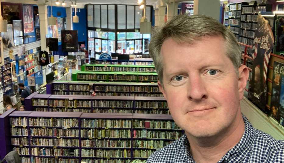 ken jennings in front of shelves and shelves of videos