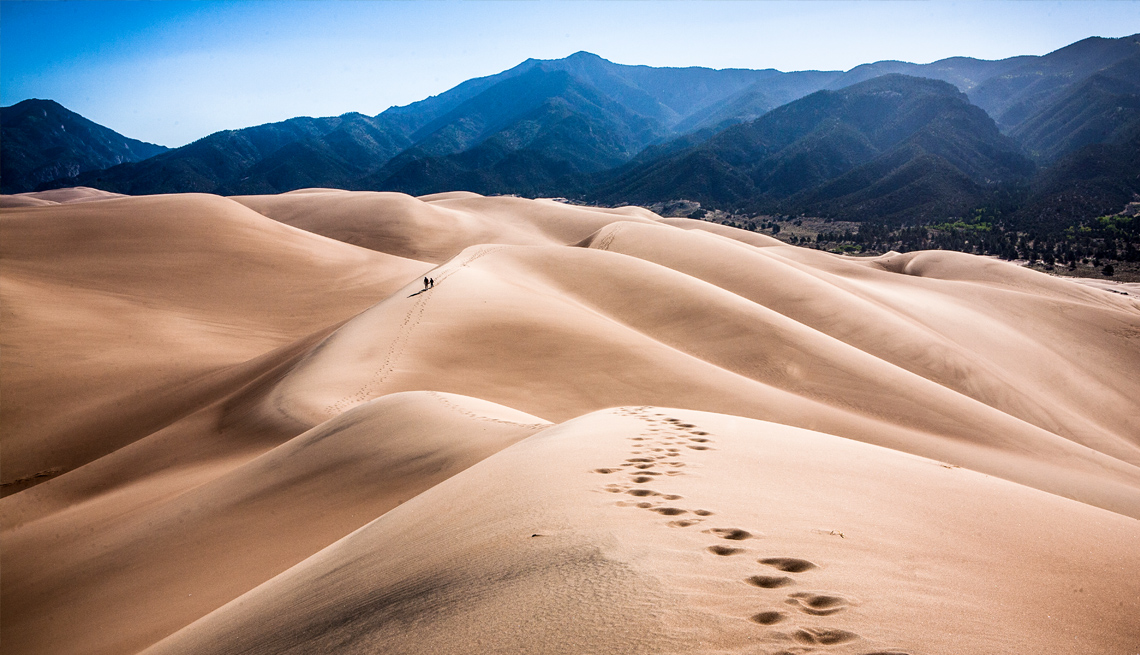 footprints in the dunes made by hikers at great sand dunes nataional park colorado