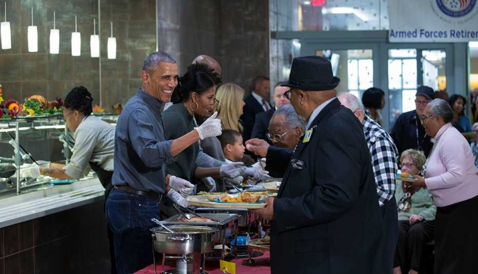 president barack obama and first lady michelle obama serve thanksgiving dinner to residents at the armed forces retirement home