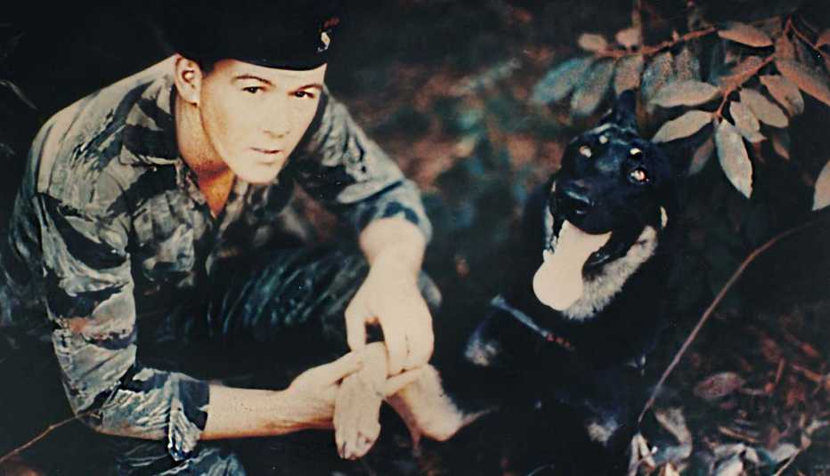 Dave Hill poses with a tracking dog