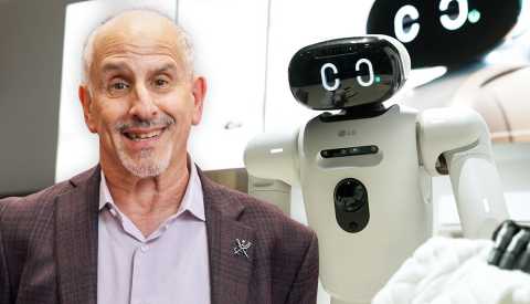 a a r p technology writer ed baig in front of a robot