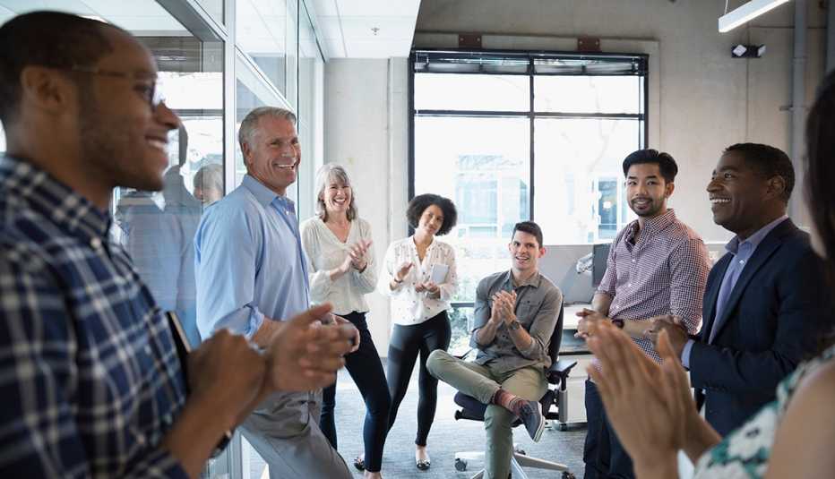 group of people standing in an office