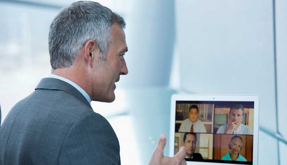 A man talking to people on a computer screen