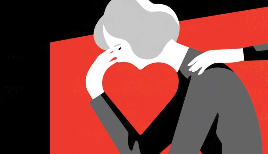 Mano tendida para consolar a una mujer de corazón roto con la cabeza en la mano y el espacio negativo entre la cara y la mano forma un corazón.