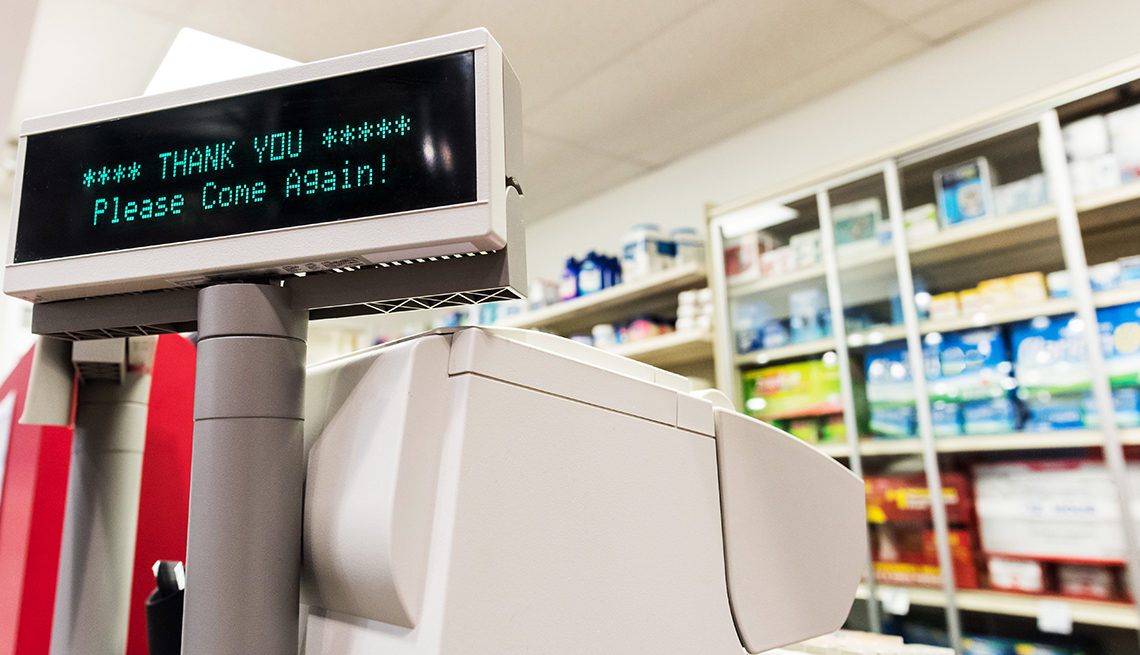 Caja registradora en una farmacia que en la pantalla dice gracias, por favor vuelve 