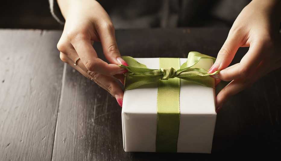 Woman Ties Bow On A Gift, AARP Home And Family, Queen Of Clutter