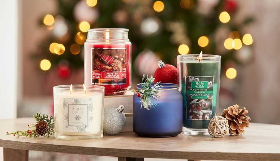 Velas de varias alturas y colores con un árbol de Navidad en el fondo