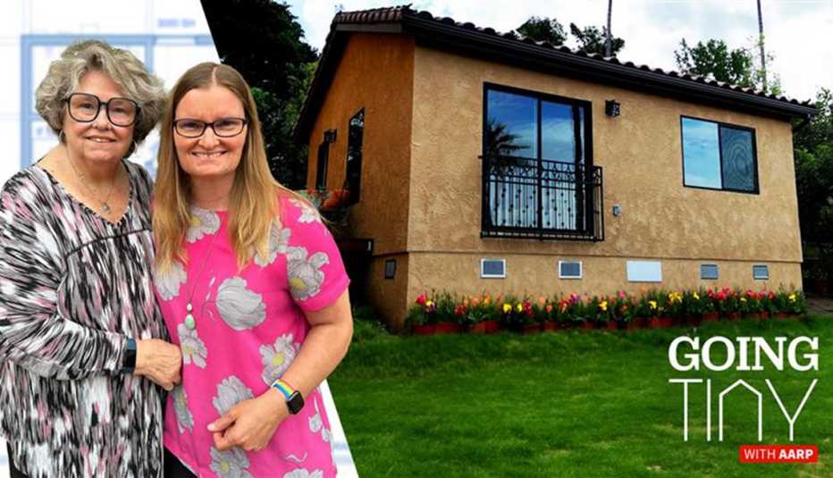 two women stand alongside a tiny home