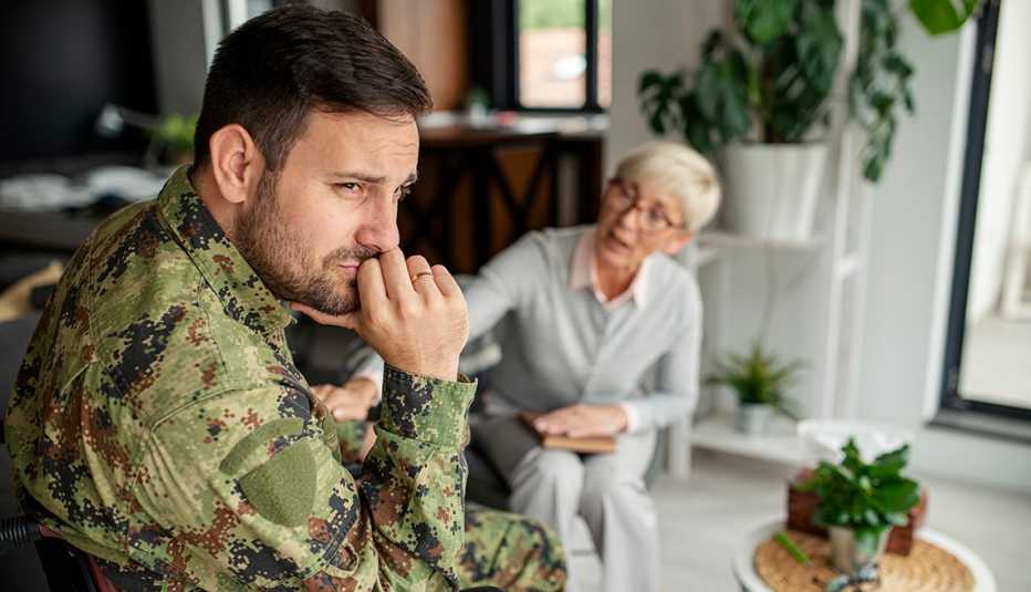 Soldado sentado con una mujer que lo consuela