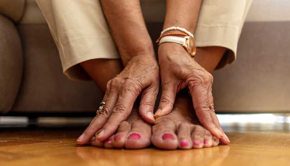 Una mujer masajea sus pies