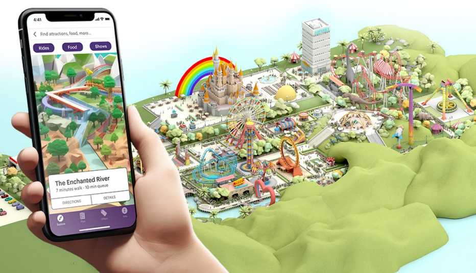 Mano sosteniendo un teléfono móvil que muestra una aplicación de un parque de diversiones