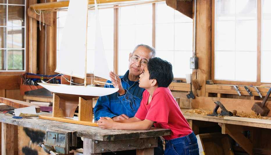 Nieto y abuelo construyendo un barco
