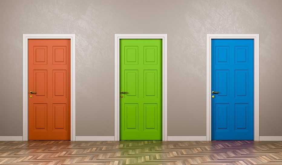 Three brightly colored closed doors along a wall