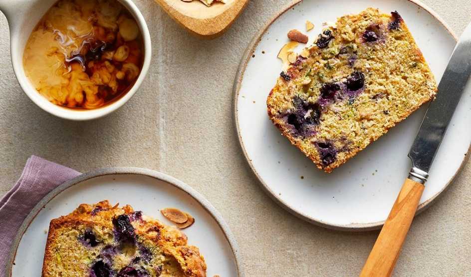 A close-up view of blueberry-lemon zucchini bread on a plate