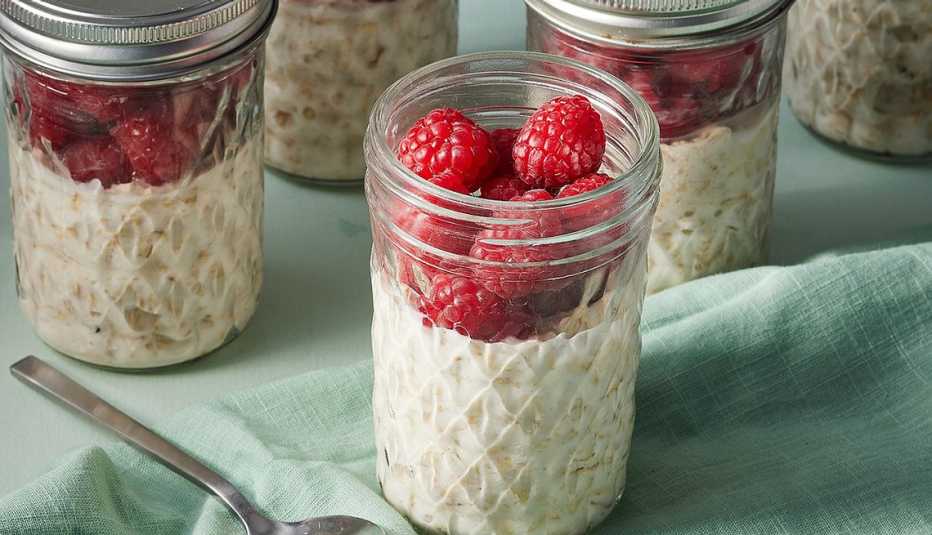 A close-up view of high-fiber raspberry-vanilla overnight oats in jars