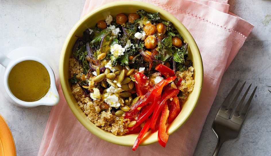 A close-up view of crispy chickpea grain bowl with lemon vinaigrette in a bowl