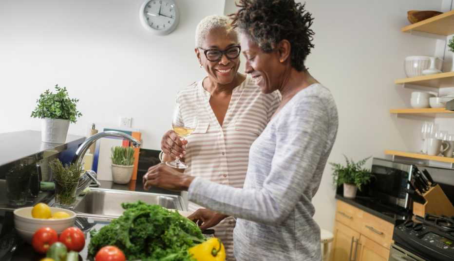 Two women preparing food together in a kitchen