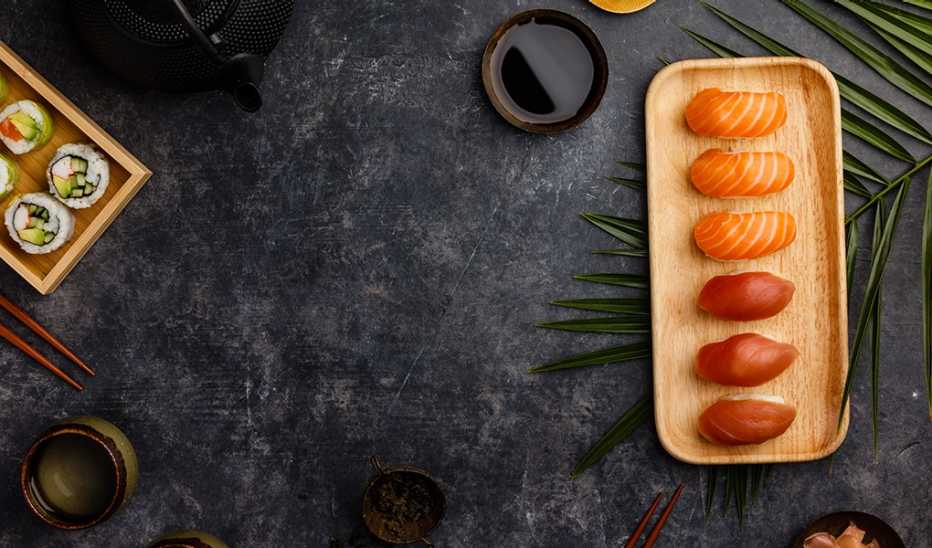 An overhead view of a sushi board with salmon and tuna